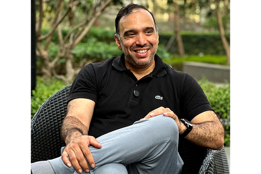 Bhadri smiling on chair outdoors